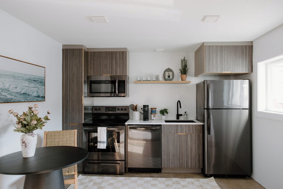 Fully equipped modern kitchen featuring full-size appliances, cooking essentials, dishwasher, and everything needed for preparing meals during your stay.