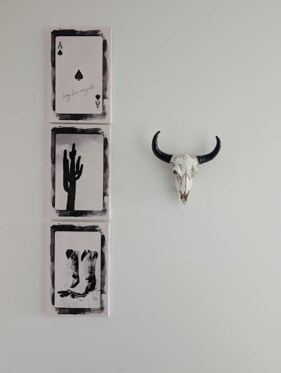 Minimalist wall decor featuring monochrome art prints and a sculptural horn accent. Clean lines and neutral tones add character and a modern, curated feel to the space, creating a calm and stylish interior detail.