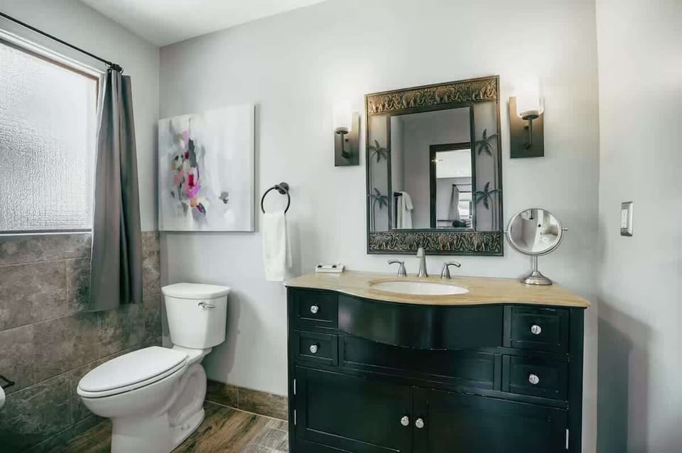 En-suite bathroom featuring a single vanity and a stand-in shower.
