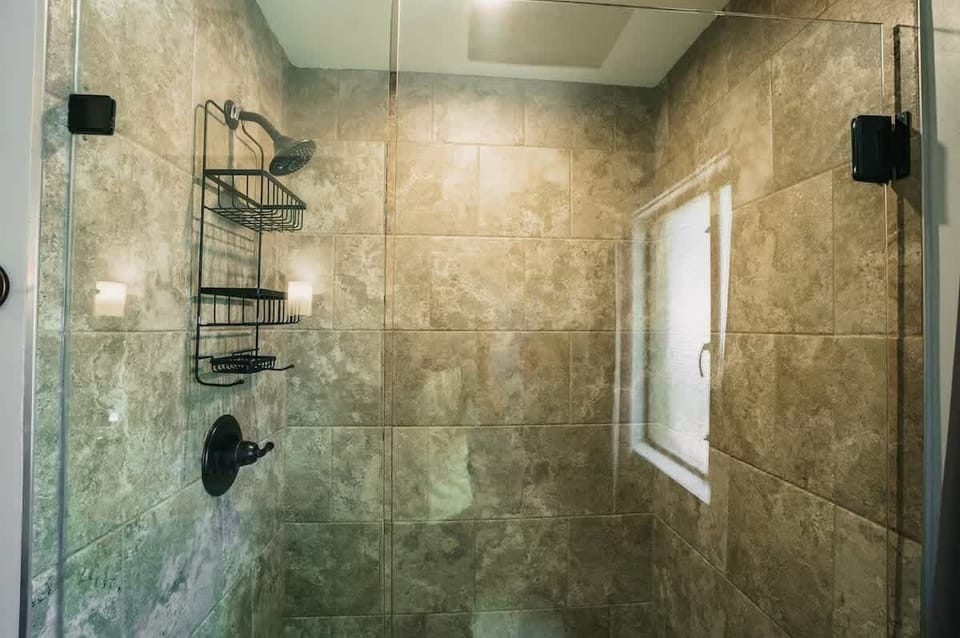 En-suite bathroom featuring a single vanity and a stand-in shower.