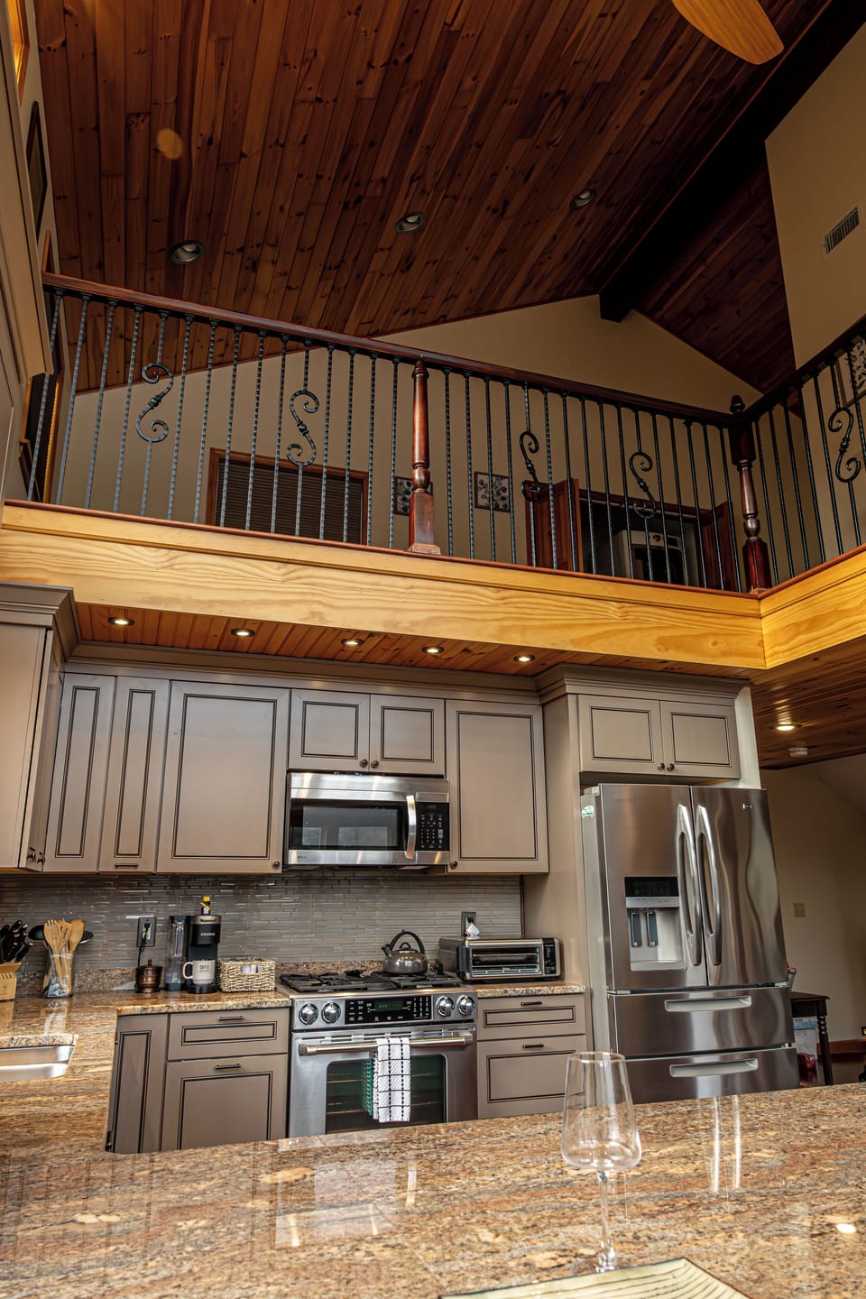 Spacious kitchen with fridge, gas oven, microwave & loft with queen sofa