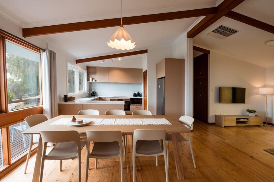 Enjoy shared meals at the central dining table, with seating for eight and plenty of space to connect.