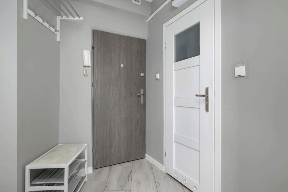 Neat entrance hallway with storage space and simple, modern finishes.