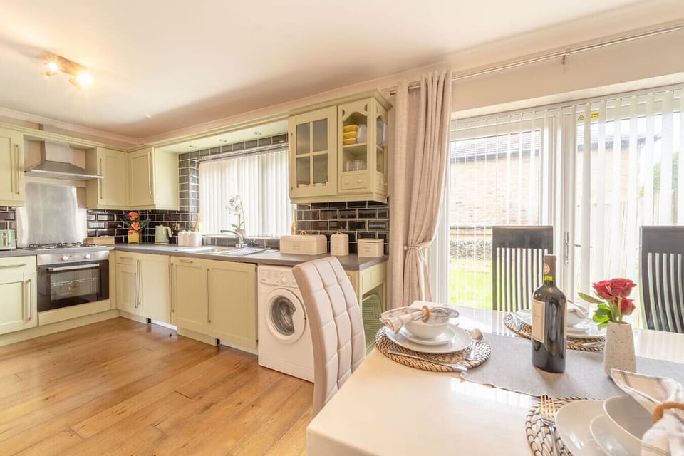 Cook and dine in the open kitchen with a dining table and doors leading outside