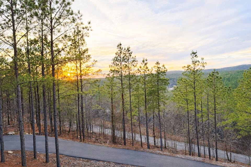 Paved driveway for the property with parking off the sides of the drive on the way up and at the top. 