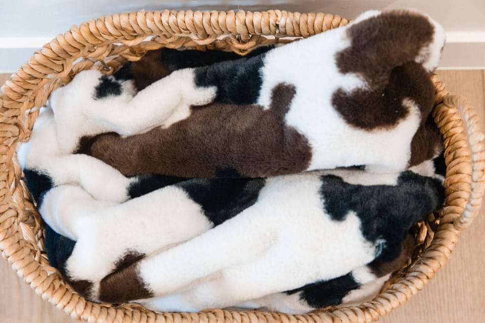 Cozy cow-print slippers await in your basket, ready to keep your feet warm throughout your stay.
