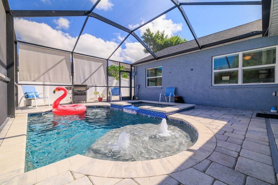 Private Backyard with Pool & Spa | Enjoy a spacious fenced yard featuring a saltwater pool, waterfall spa, and hot tub. It’s the perfect spot to relax, read, or cool off after a day at the beach.