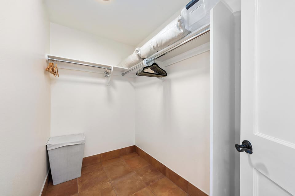 Your spacious walk-in closet awaits with ample hanging space and storage for all your vacation wardrobe essentials.