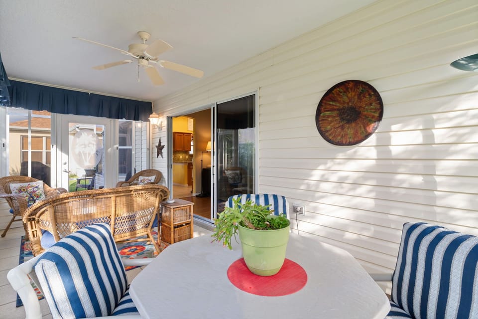 Unwind on your private patio with wicker seating, overhead fan, and charming coastal touches perfect for morning coffee.