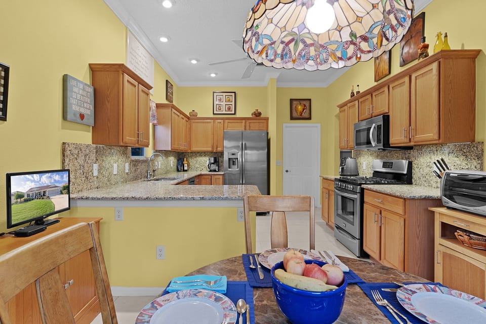Your fully equipped kitchen invites culinary adventures with granite counters, stainless appliances, and a cheerful breakfast nook ready for memorable meals.