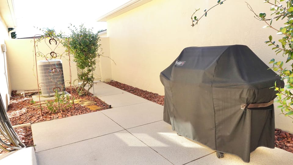 Your private patio features a covered BBQ grill and landscaped space, perfect for outdoor cooking and relaxing in the sunshine.