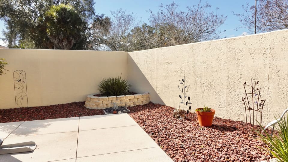 Your private courtyard features artistic wall designs and desert landscaping, perfect for peaceful moments outdoors.