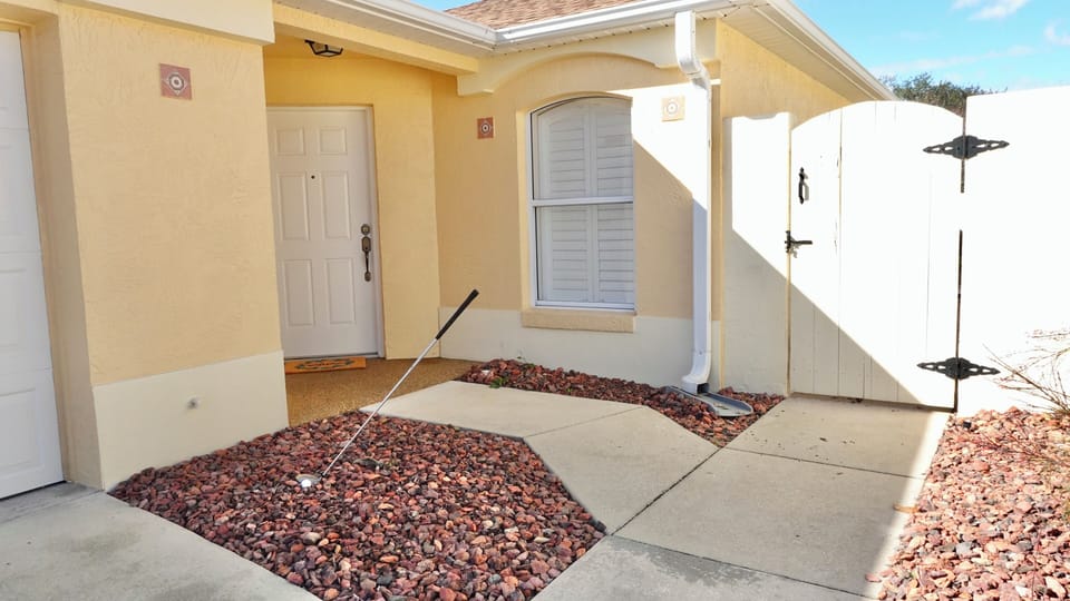 Bright, welcoming entrance with decorative landscaping leads to your comfortable vacation home retreat.