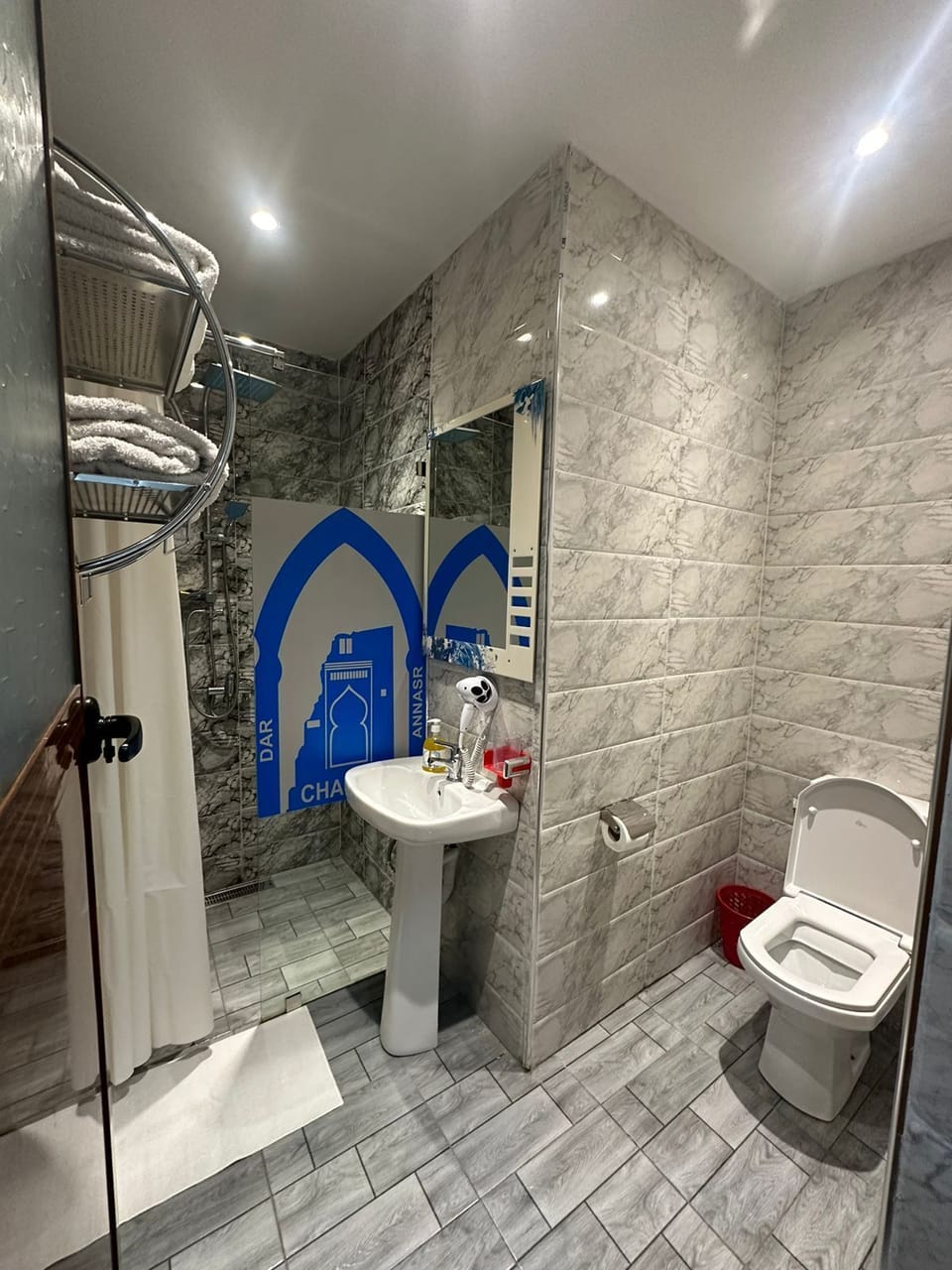 Separate tub and shower, hair dryer, towels, shampoo