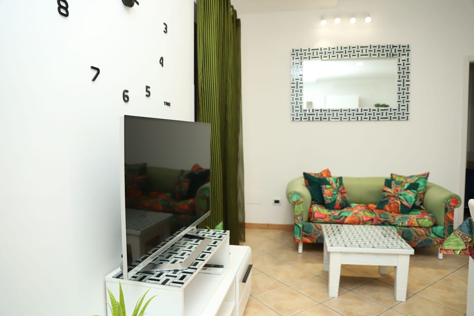 Family Apartment, Balcony, Beach View | Living area | 30-inch flat-screen TV with satellite channels