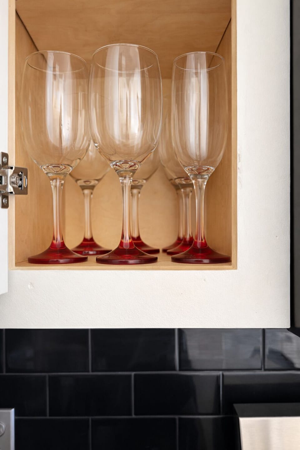Well-stocked kitchen with glassware for entertaining.