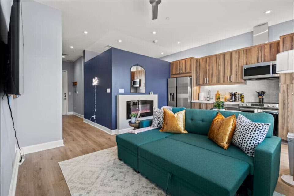 Kick back in style on our plush velvet sectional. Whether you`re hosting a movie night on the massive screen or grabbing drinks at the bar, this open-concept lounge is designed for good times and great company.