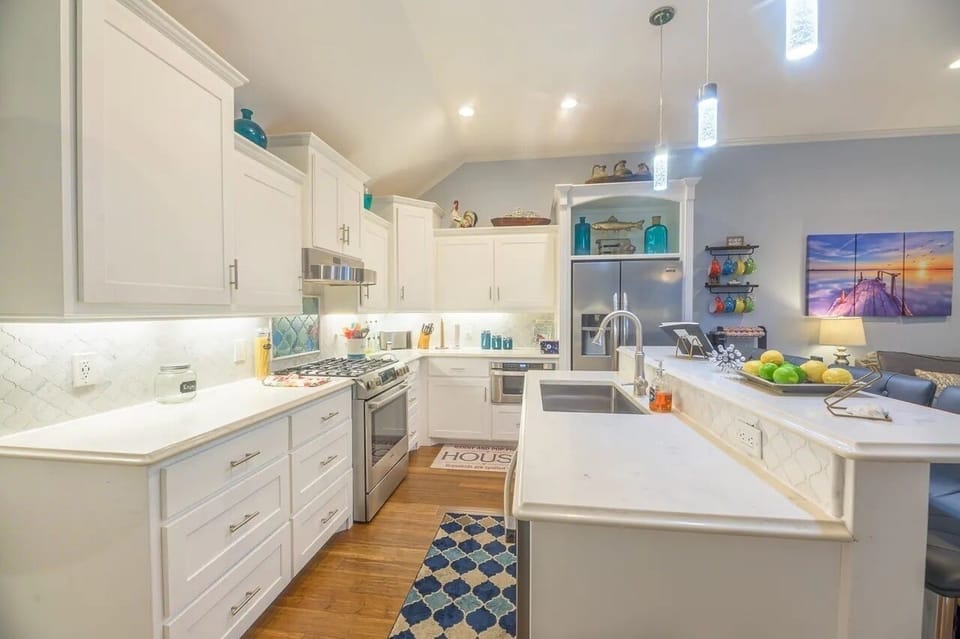 Fully equipped kitchen with stainless steel appliances and gas stove