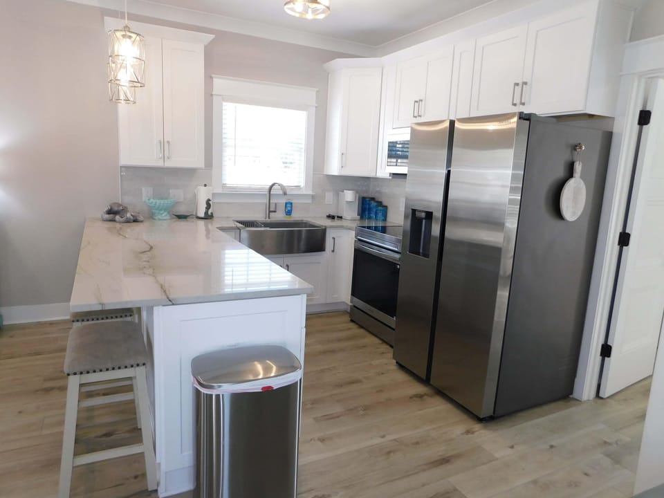 Bright, modern kitchen with stainless steel appliances and island seating