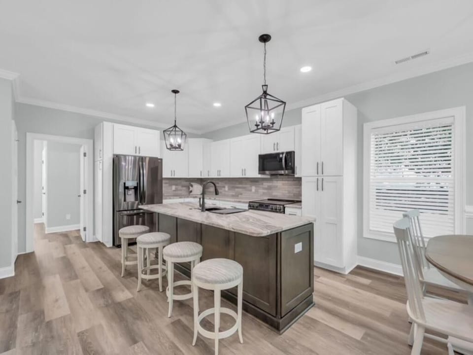 Spacious kitchen with modern island seating and natural light