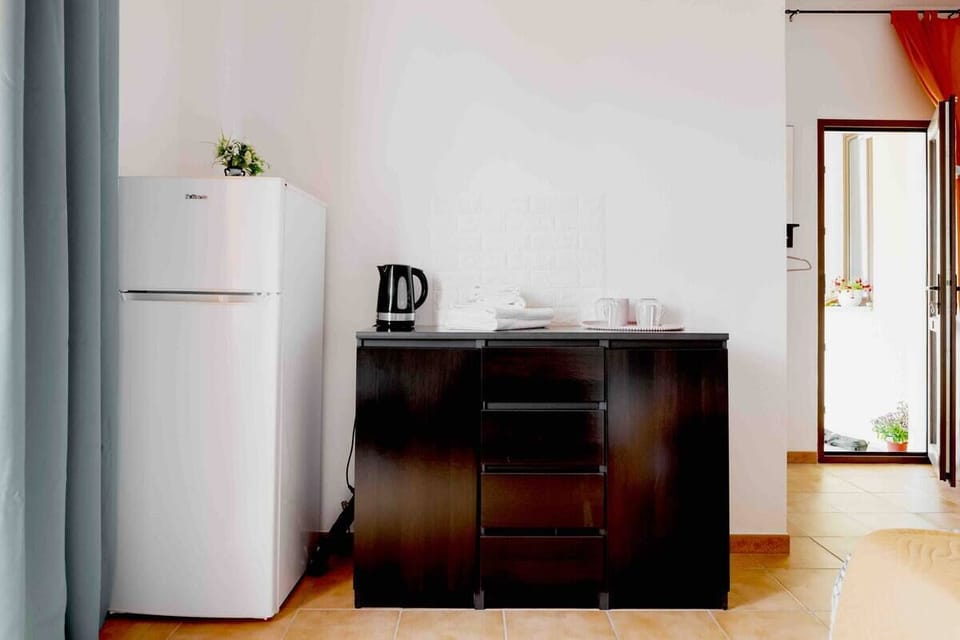 Fridge, kettle, and cupboard