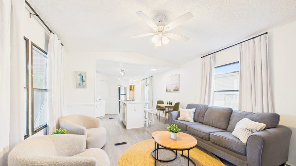 Open concept living area with TV and stylish furnishings + sleeper sofa (sleeps 2)