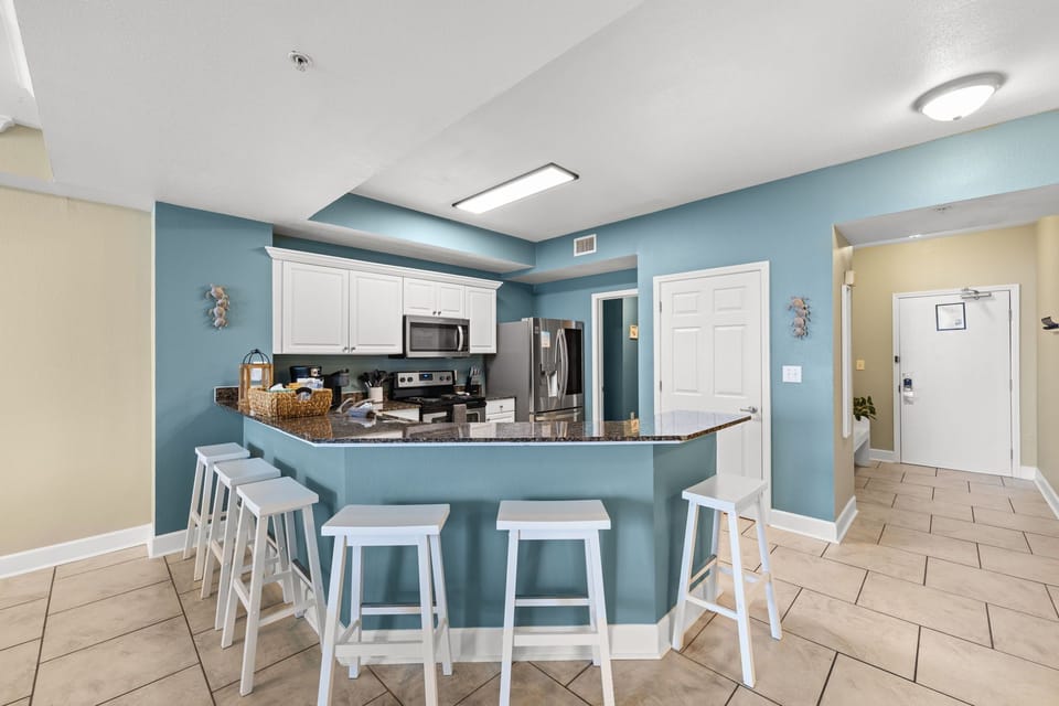 Spacious kitchen bar seating for six—perfect for family meals and coastal gather