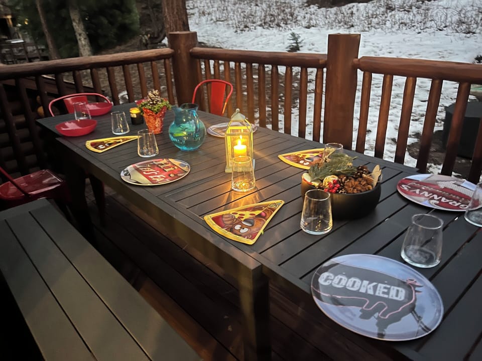 Large extending patio table for dining alfresco by the BBQ grill in the deck