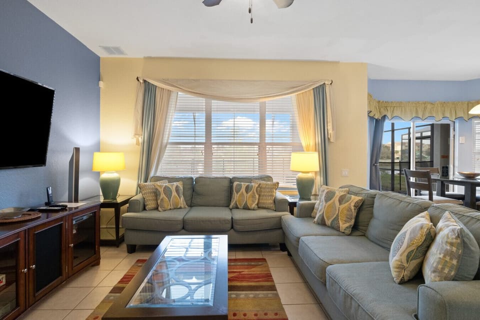 Spacious living room with plush sectional seating, natural light, and smart TV for family gatherings