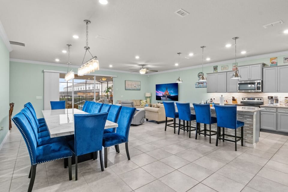 Spacious open-plan dining room with stylish seating and fully equipped kitchen.