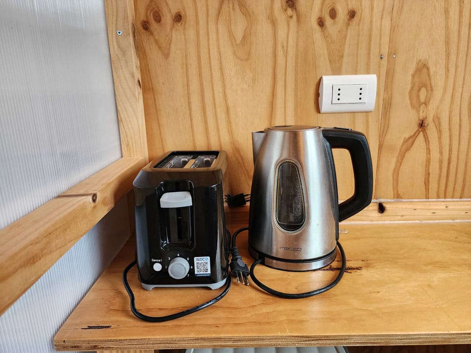 Coffee station w/ kettle & machine on wood counter for easy mornings.