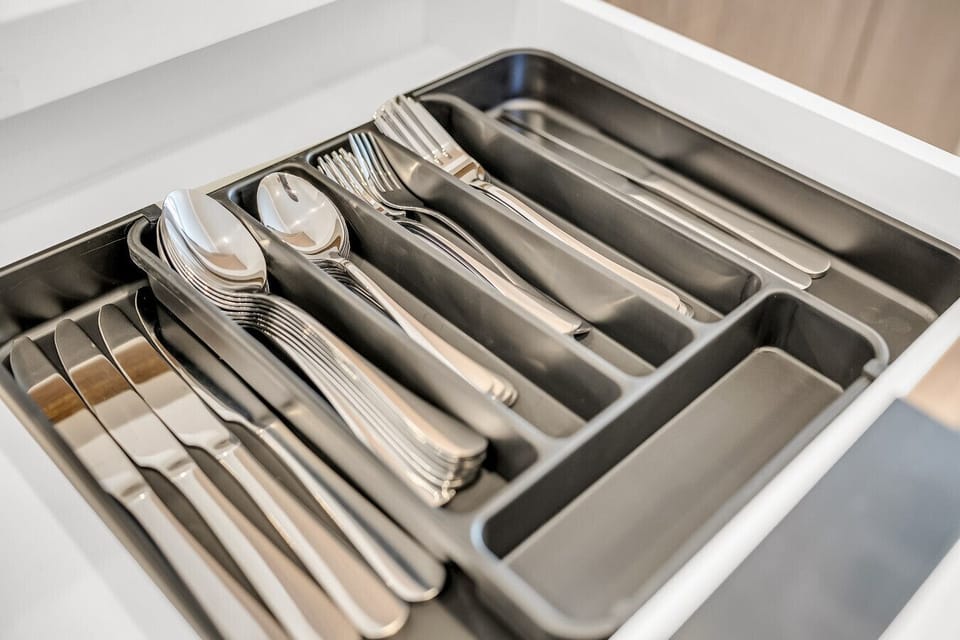 Everything you need for dining is neatly organized and ready to use in the fully stocked silverware drawer.