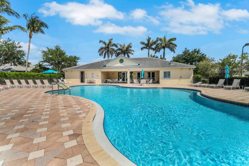 The heated, resort-style community pool and sun deck — the perfect place to soak up the Florida sun after exploring the nearby beaches.