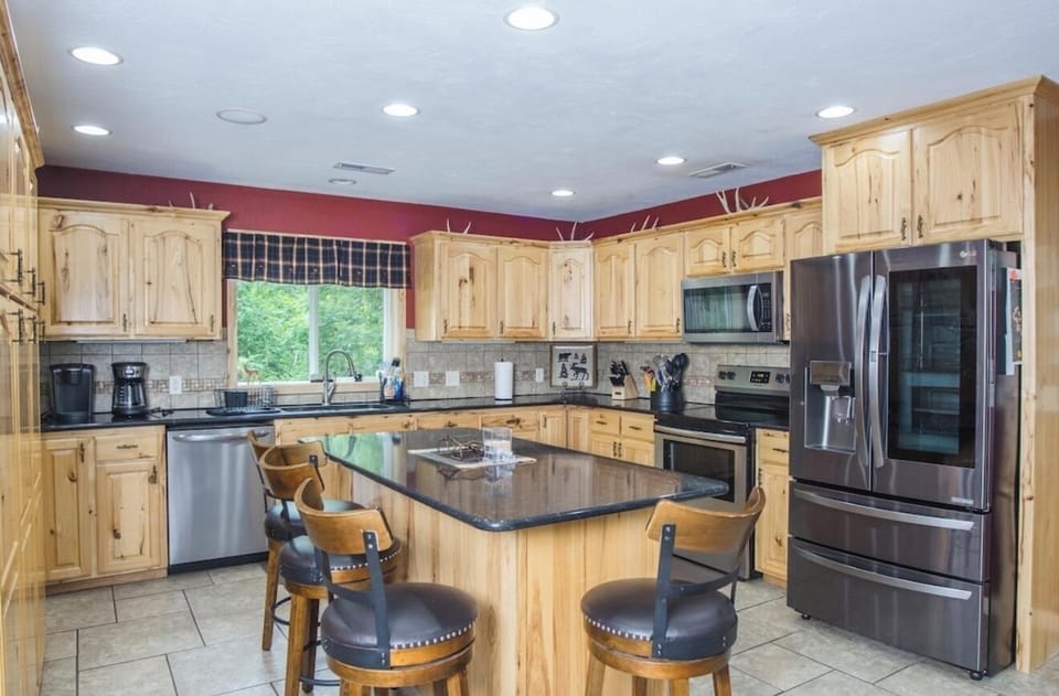 The kitchen is large and fully stocked with views to the lake while cooking