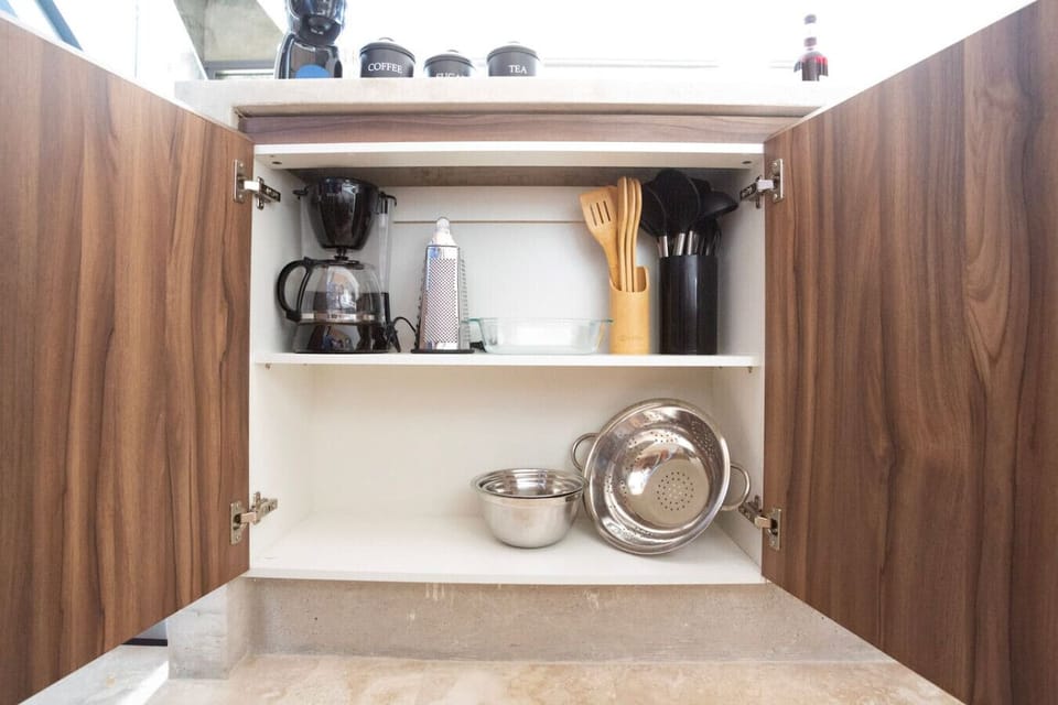 Enjoy the convenience of a fully stocked kitchenette with essential cookware and coffee-making amenities.