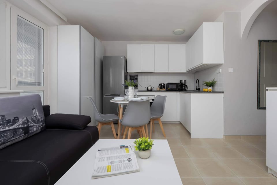 Spacious living area with sofa and dining table.