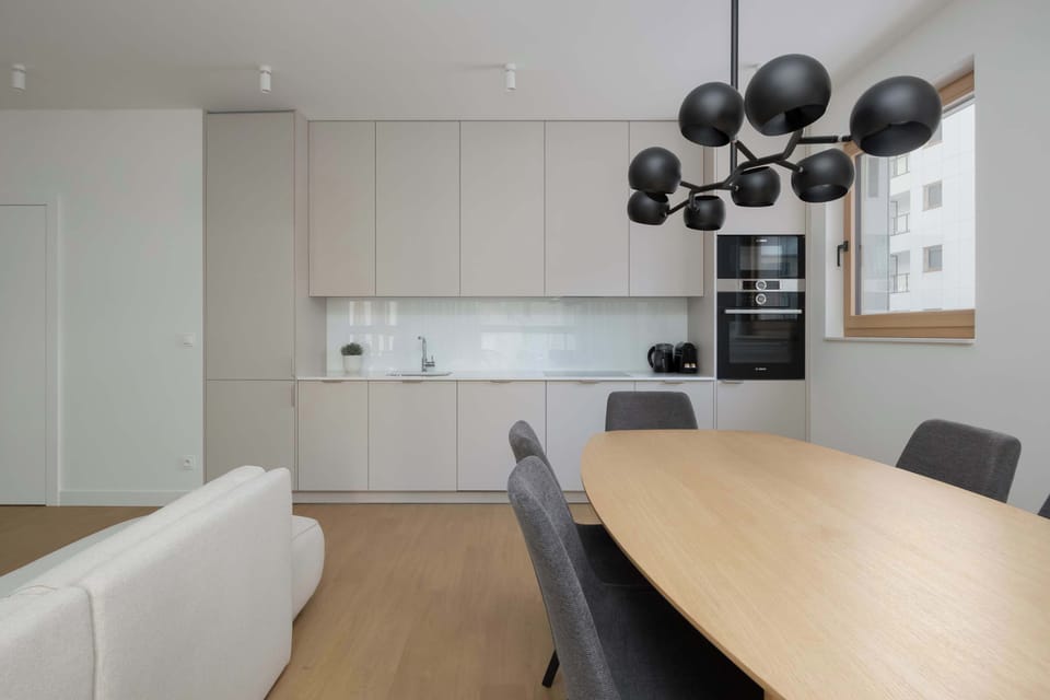 Dining area with table and modern lighting.