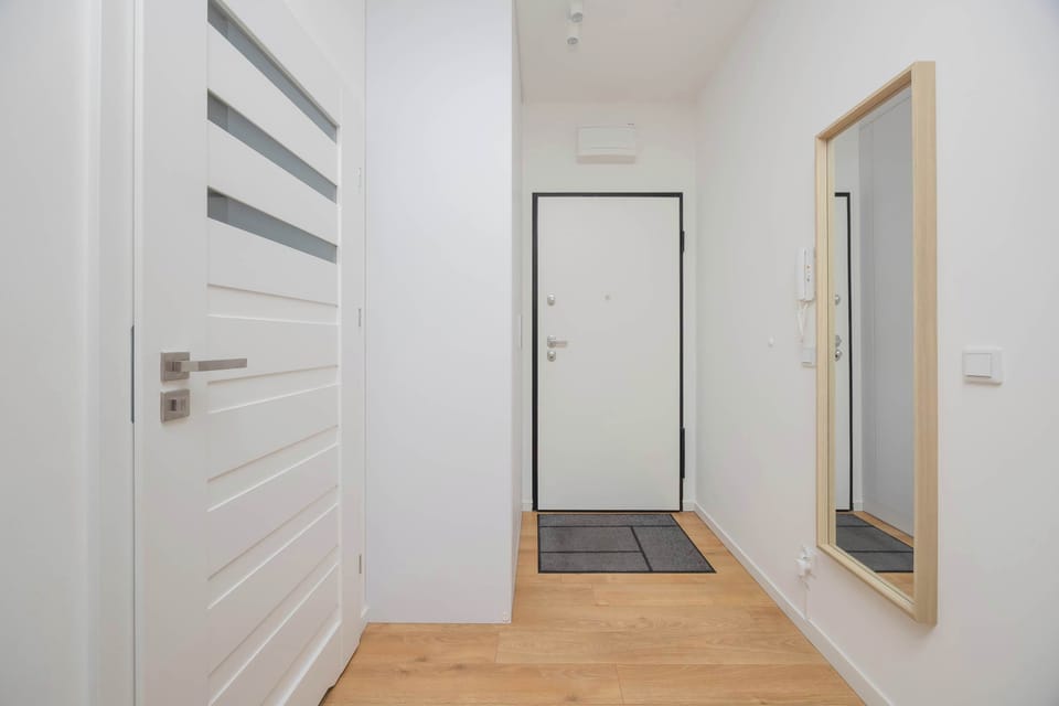 Apartment hallway with storage and doors.