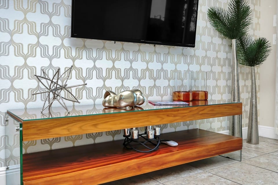 Modern entertainment console with decorative accents and a mounted flat-screen television