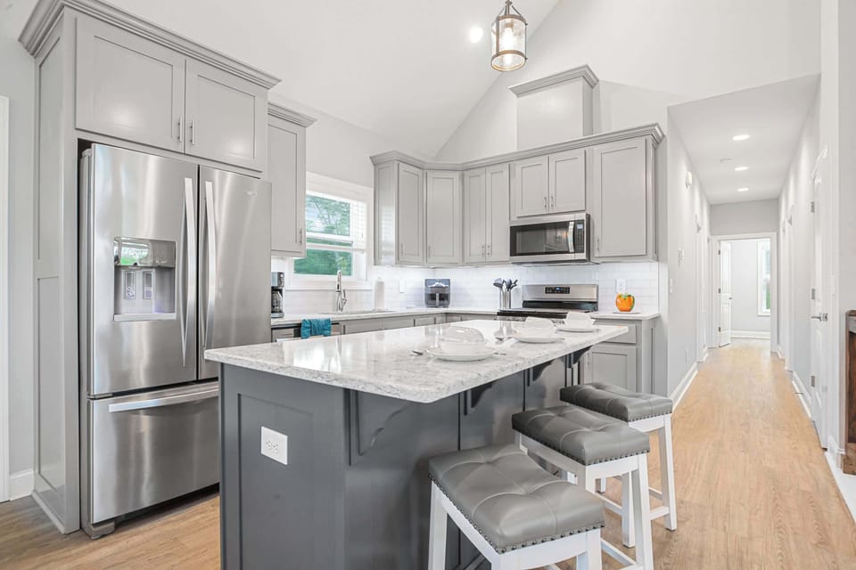 Modern kitchen with a large marble island and stainless steel appliances