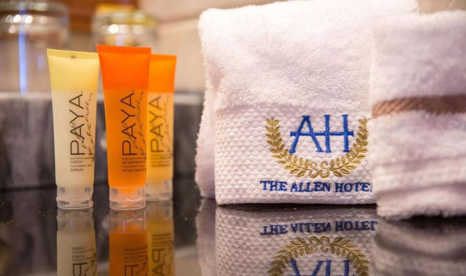 Bathroom amenities with folded towels and branded toiletries