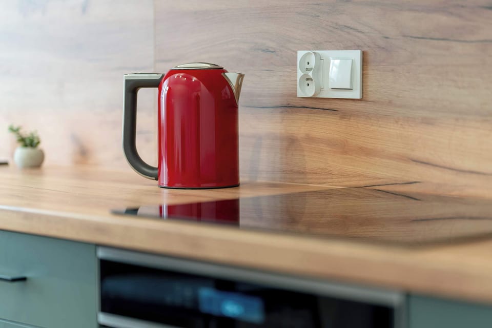 Detailed kitchen corner with red electric kettle