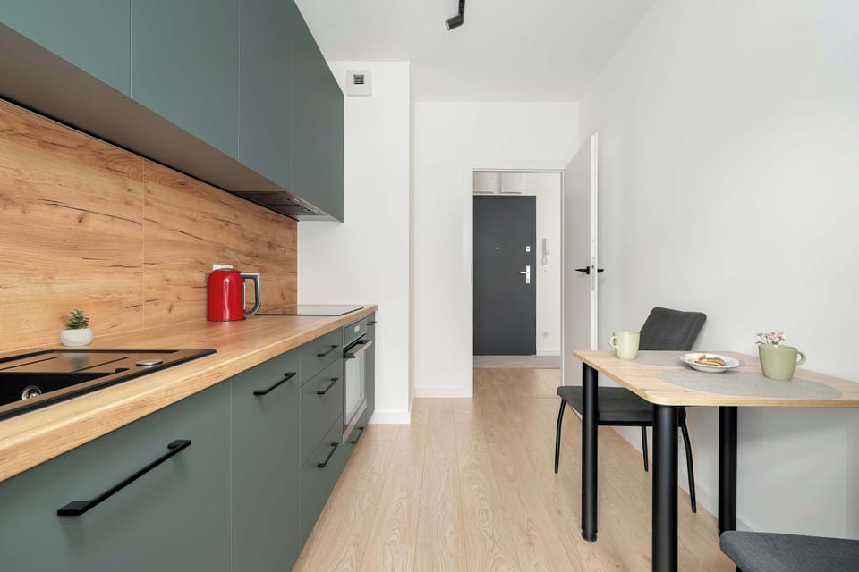 Modern kitchen in navy and wood tones with full amenities