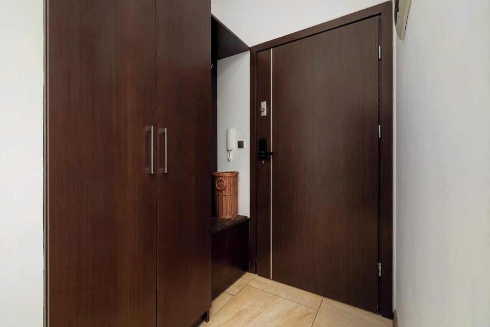 Entrance hallway with wooden doors and warm finishes.