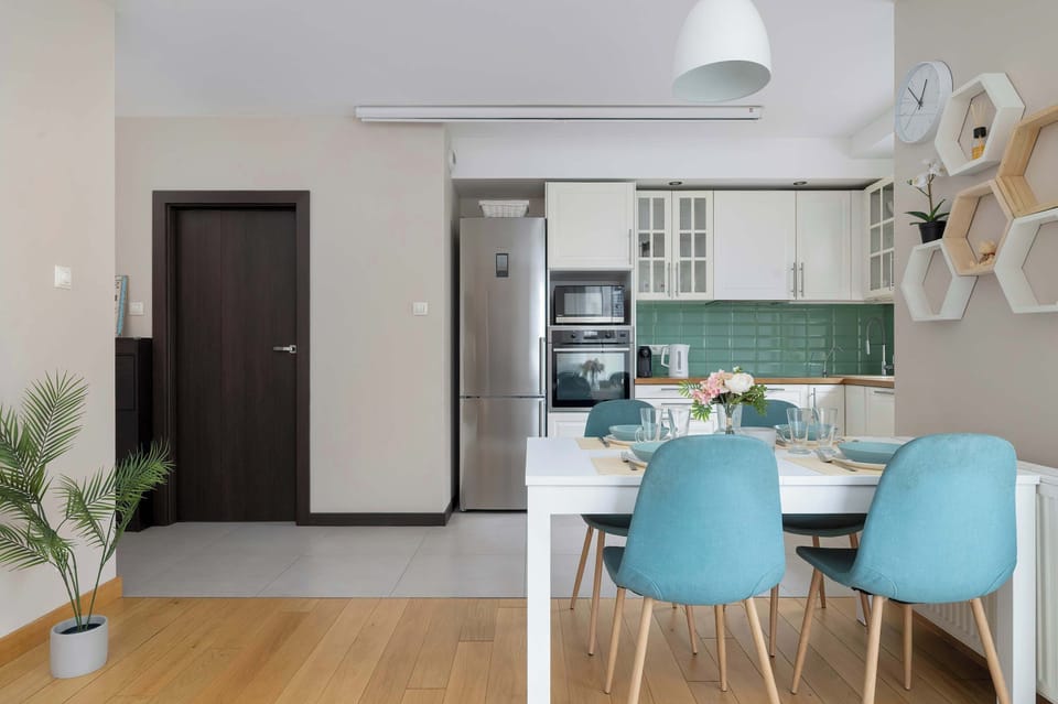 The sleek design of the kitchenette blending seamlessly with the living area.
