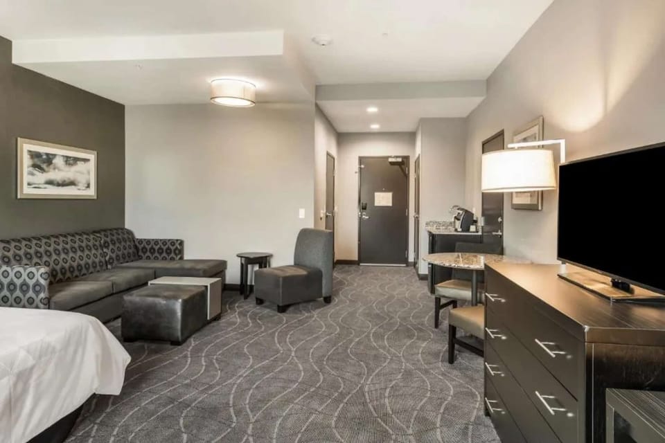 Spacious room with cozy seating, desk area, and soft lighting