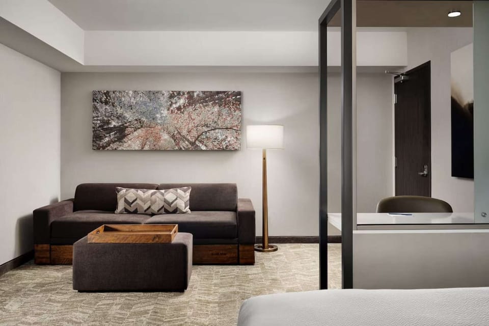 Comfy sitting area with dark couch and floor lamp
