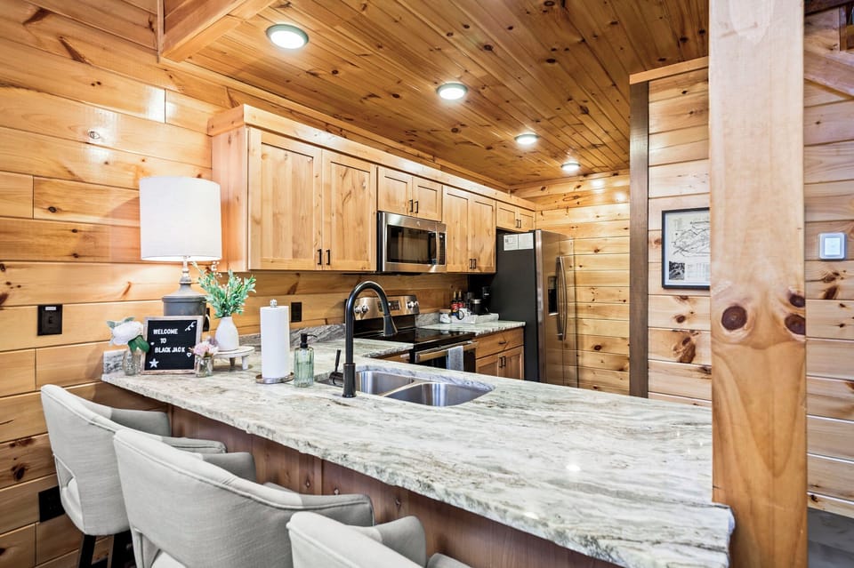 Dine at the table for six, supplemented by three barstools at the kitchen counter.