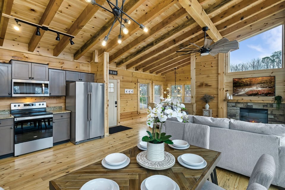 Head on into the cabin, here is the upper level, with a vaulted ceiling, spacious open plan layout and modern touches throughout - this is the perfect place for you and your family to hang out