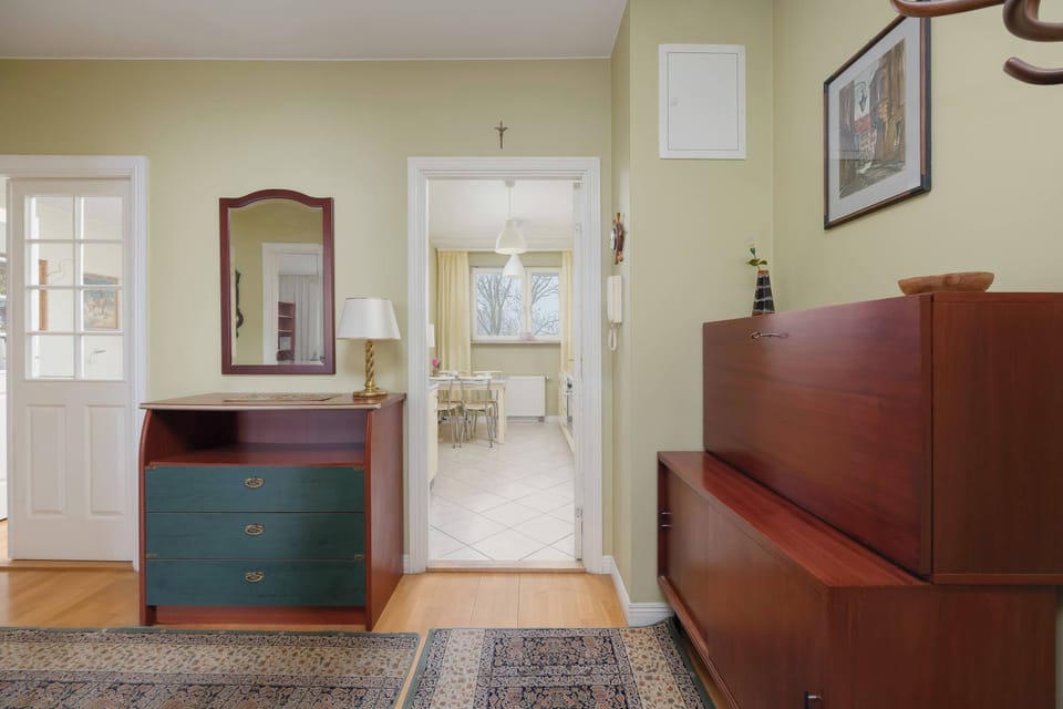 Bright hallway view with storage units, wall décor, and practical circulation space.